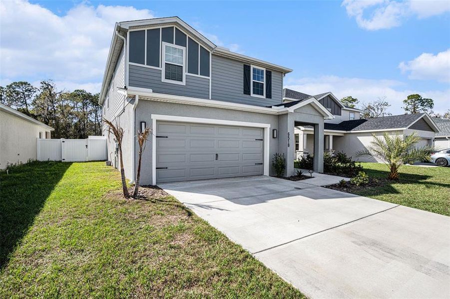 Front exterior of a new home in , Zephyrhills, FL, highlighting curb appeal (Image 1). Front exterior of a new home in , Zephyrhills, FL, highlighting curb appeal (Image 1).