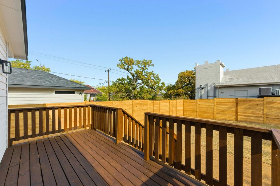 Wooden deck featuring a fenced backyard