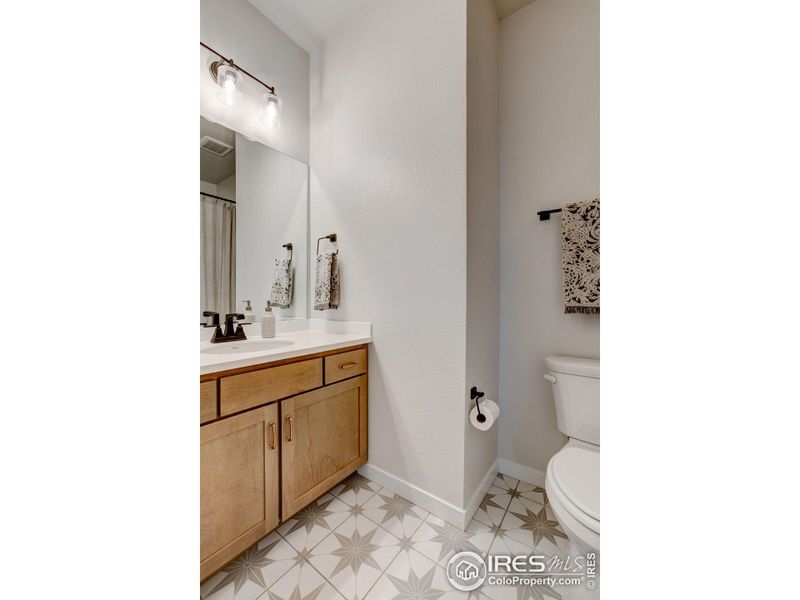 Guest Bathroom with upgraded cabinetry and flooring