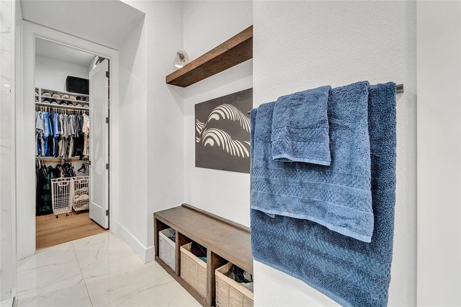 Mudroom featuring light marble finish floors and baseboards Mudroom featuring light marble finish floors and baseboards