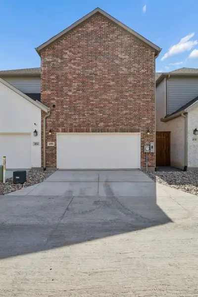 Exterior details and patio area of a home in Newman Village Townhomes, Frisco (Image 21).