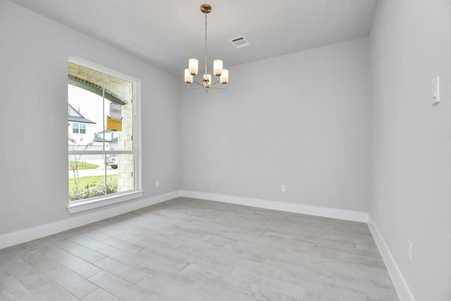 Create lasting memories with your family and friends at the dining table! This expansive dining room showcases sophisticated flooring, custom paint, and seamlessly connects to the family room and kitchen, providing an open and inviting atmosphere. Sample photo of completed home with similar floor plan. Actual colors and selections may vary. Create lasting memories with your family and friends at the dining table! This expansive dining room showcases sophisticated flooring, custom paint, and seamlessly connects to the family room and kitchen, providing an open and inviting atmosphere. Sample photo of completed home with similar floor plan. Actual colors and selections may vary.