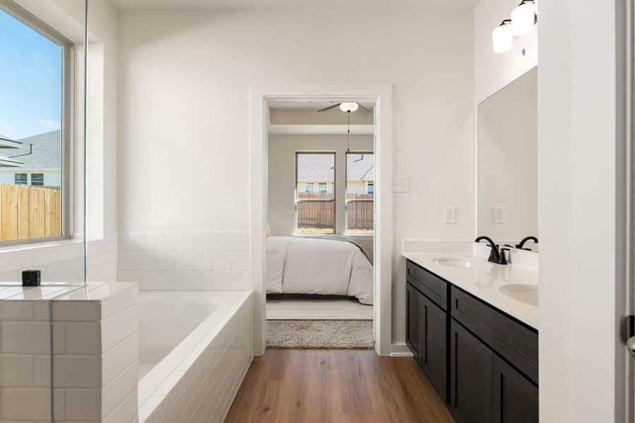 The direct, open doorway access to the private primary bedroom ensures a convenient, en suite experience, enhancing daily routine and providing a personal retreat. *Virtually Staged The direct, open doorway access to the private primary bedroom ensures a convenient, en suite experience, enhancing daily routine and providing a personal retreat. *Virtually Staged