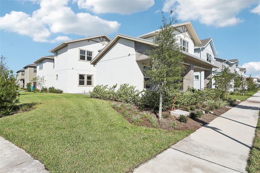 Front exterior of a new home in Laureate Park, Orlando, FL, highlighting curb appeal (Image 27).