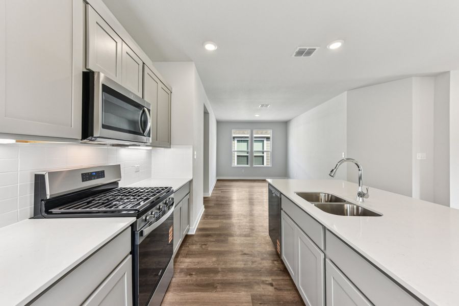 A kitchen with white cabinets.