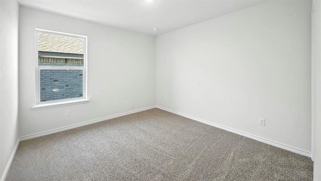 Empty room with carpet flooring and baseboards Empty room with carpet flooring and baseboards
