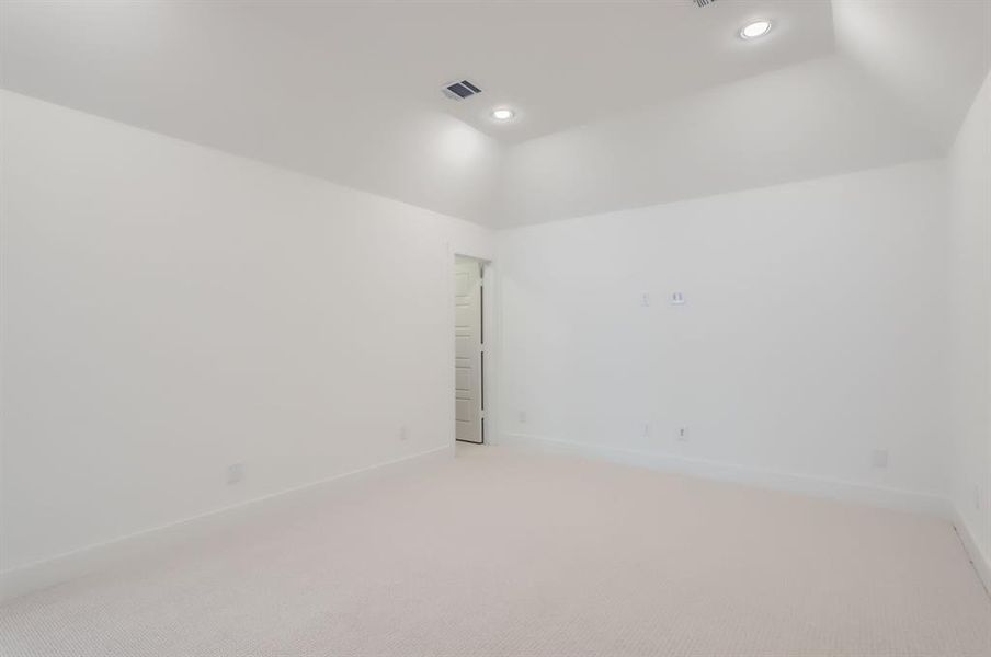 Unfurnished room featuring lofted ceiling and carpet flooring