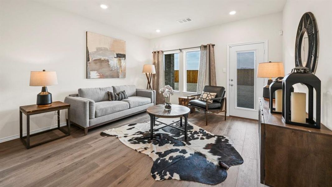 Open concept living area featuring wood-finish flooring