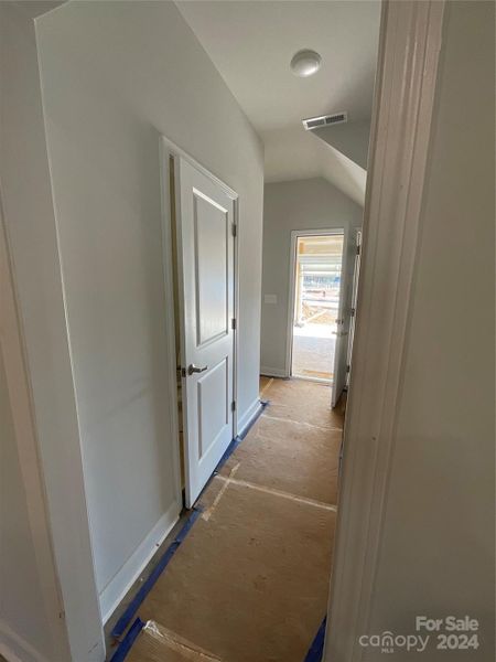 Hallway to garage half bath and drop zone