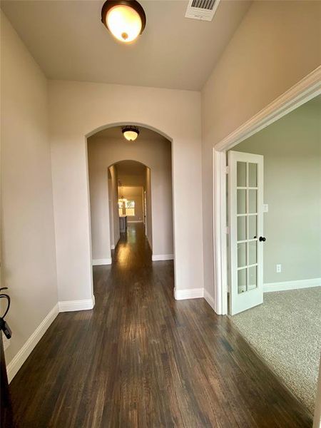 Entrance with elegant arches and rich hardwoods Entrance with elegant arches and rich hardwoods