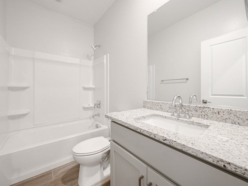 A bathroom with a marble countertop.
