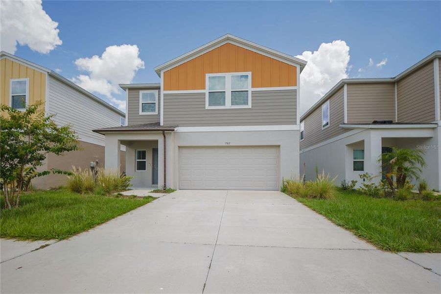 Front exterior of a new home in Pasadena Point, Wesley Chapel, FL, highlighting curb appeal (Image 1). Front exterior of a new home in Pasadena Point, Wesley Chapel, FL, highlighting curb appeal (Image 1).