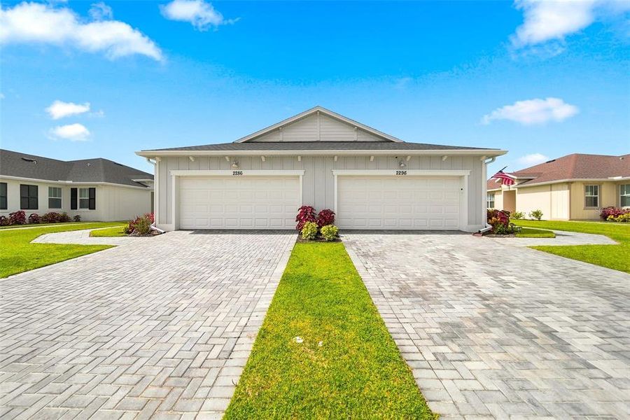 Front exterior of a new home in The Timbers at Everlands, Palm Bay, FL, highlighting curb appeal (Image 27).