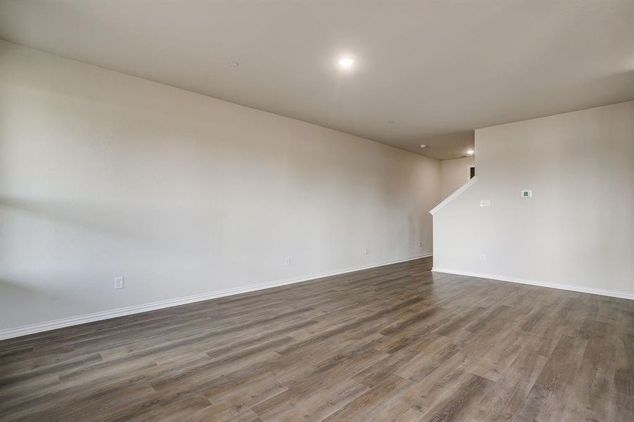 Unfurnished room featuring wood finished floors and recessed lighting