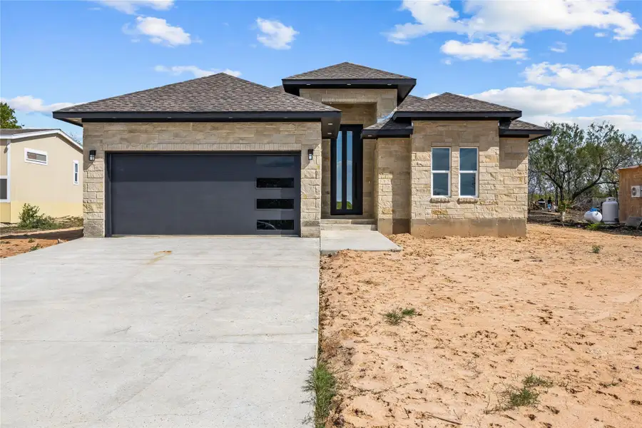 Front of home featuring metal door.