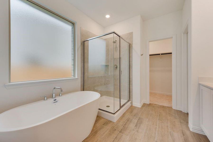 Bathroom featuring vanity and plus walk in shower