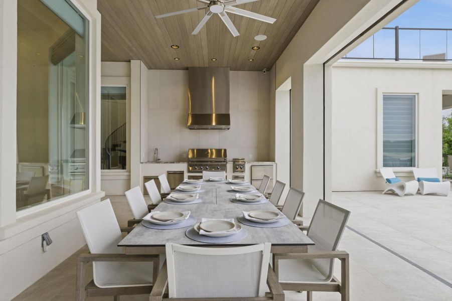 View of patio / terrace with an outdoor kitchen / dining area and a ceiling fan