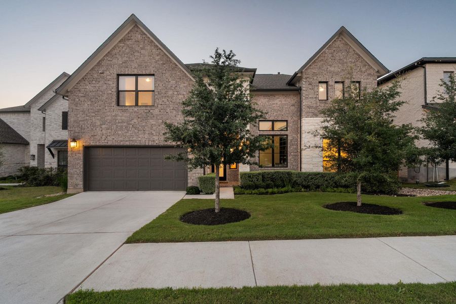 Front exterior of a new home in Sweetwater - 60', Austin, TX, highlighting curb appeal (Image 21). Front exterior of a new home in Sweetwater - 60', Austin, TX, highlighting curb appeal (Image 21).