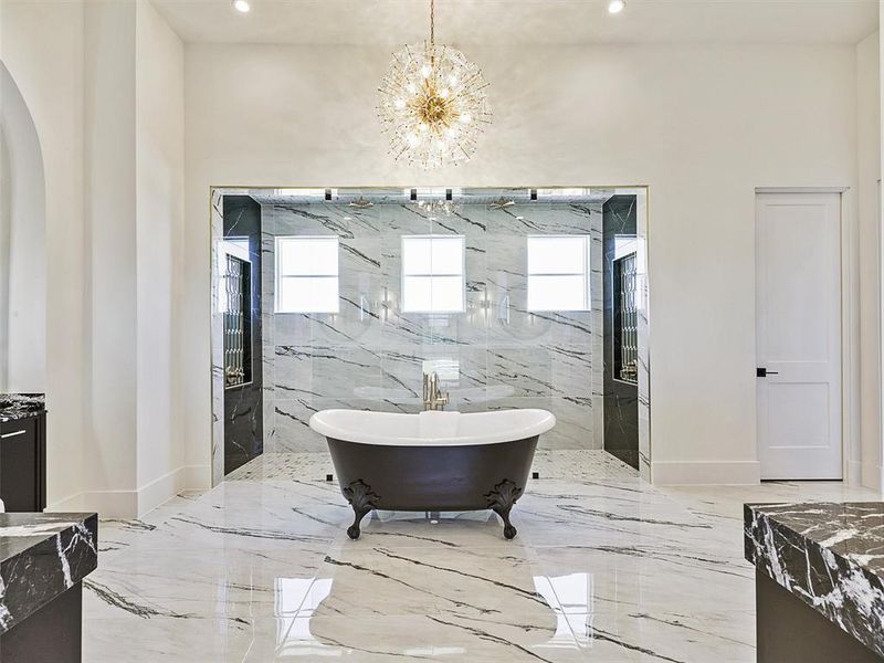 Bathroom featuring vanity, plenty of natural light, and separate shower and tub