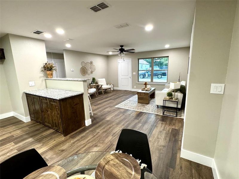 Living room with dark wood finished floors, ceiling fan, and recessed lighting