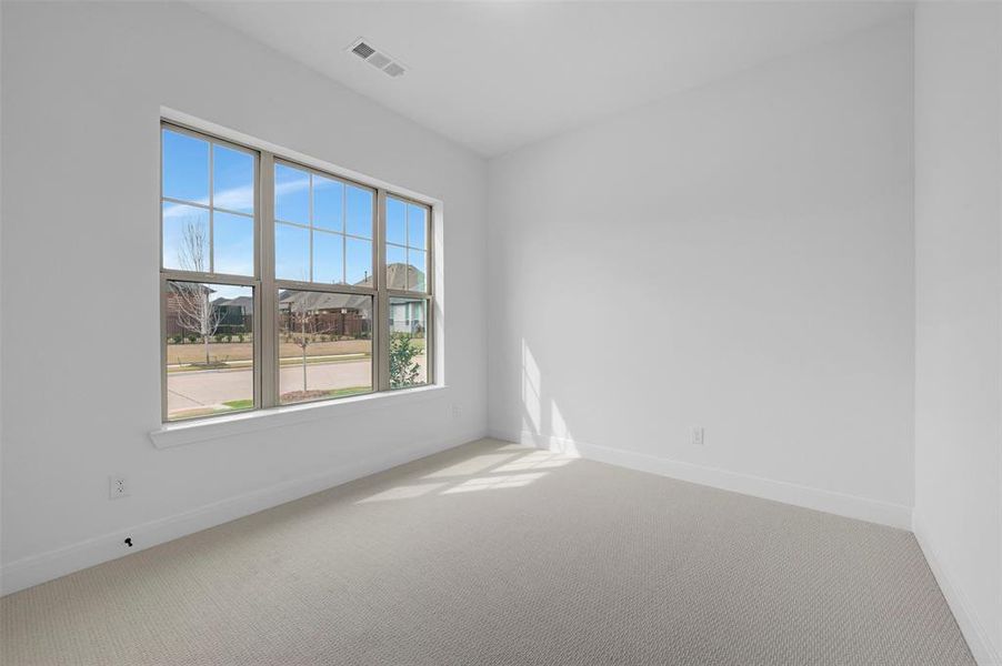 Carpeted empty room with baseboards