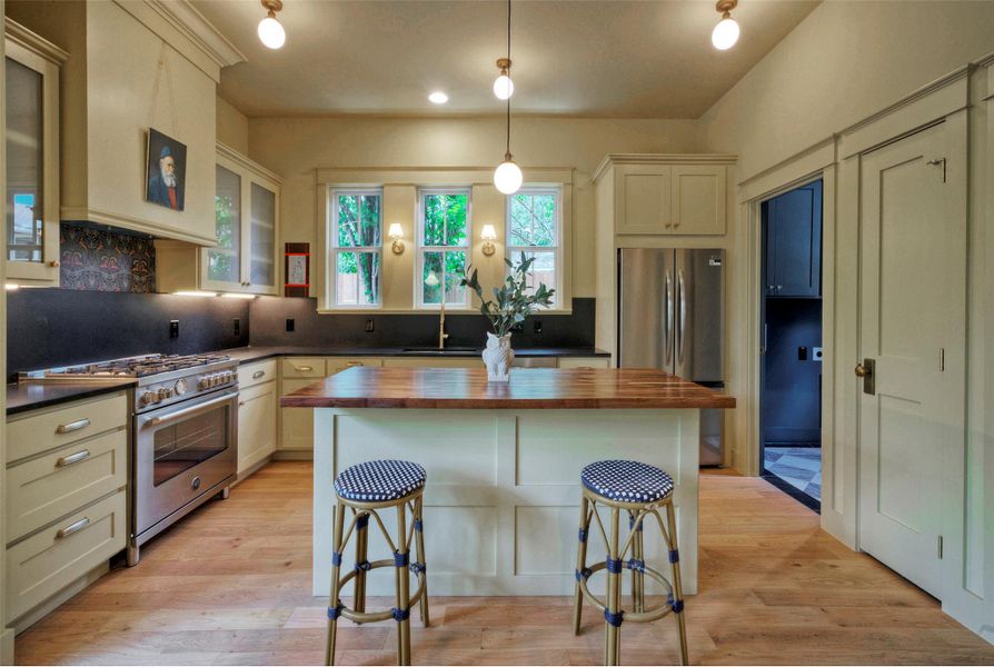 An inviting kitchen provides a central island with counter seating and a full complement of high-end appliances.