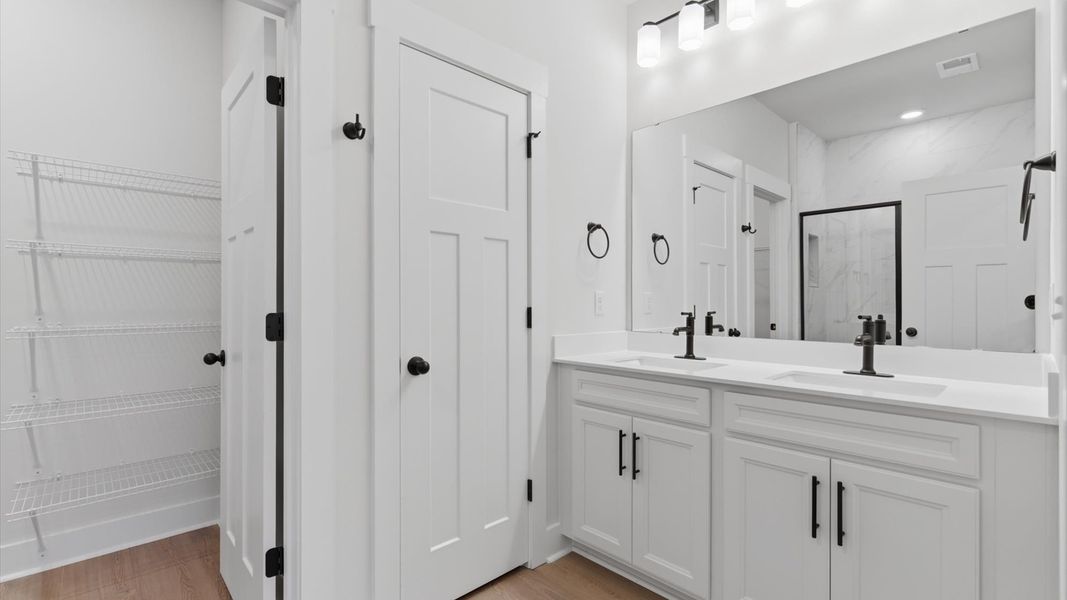 Exceptional en-suite with dual vanity and glass-enclosed walk-in shower for superior everyday comfort at Pelham Crossing