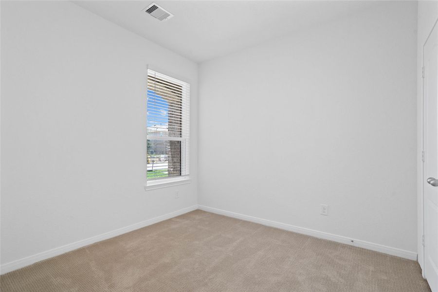 This secondary bedroom offers comfort and style with plush carpet flooring, neutral paint tones, a large window with blinds, and ample sized closet space. This secondary bedroom offers comfort and style with plush carpet flooring, neutral paint tones, a large window with blinds, and ample sized closet space.