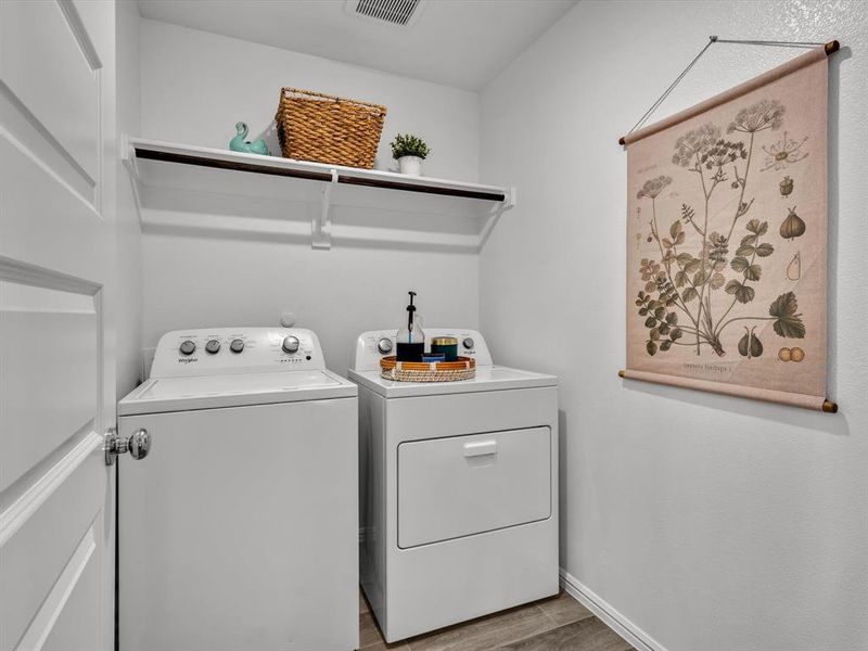 Great sized separate laundry room is positioned off the foyer.