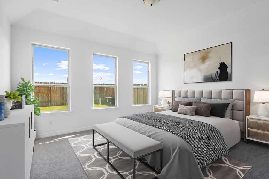 The primary bedroom is generously sized, creating a tranquil and spacious retreat that offers ample room for relaxation. Featuring plush carpet, high ceilings, fresh paint, and large windows that lets in natural lighting throughout the day.
