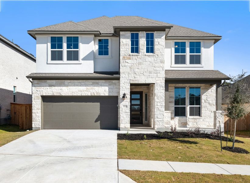 Front exterior of a new home in Heritage, Dripping Springs, TX, highlighting curb appeal (Image 1). Front exterior of a new home in Heritage, Dripping Springs, TX, highlighting curb appeal (Image 1).