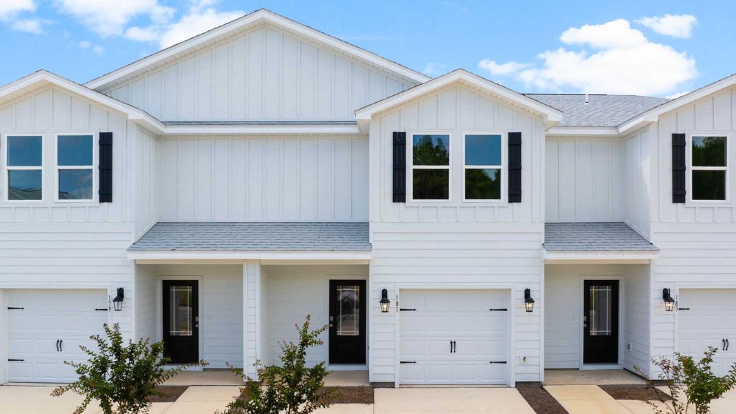 Front exterior of a new home in Genoa Landing Townhomes, Freeport, FL, highlighting curb appeal (Image 1).