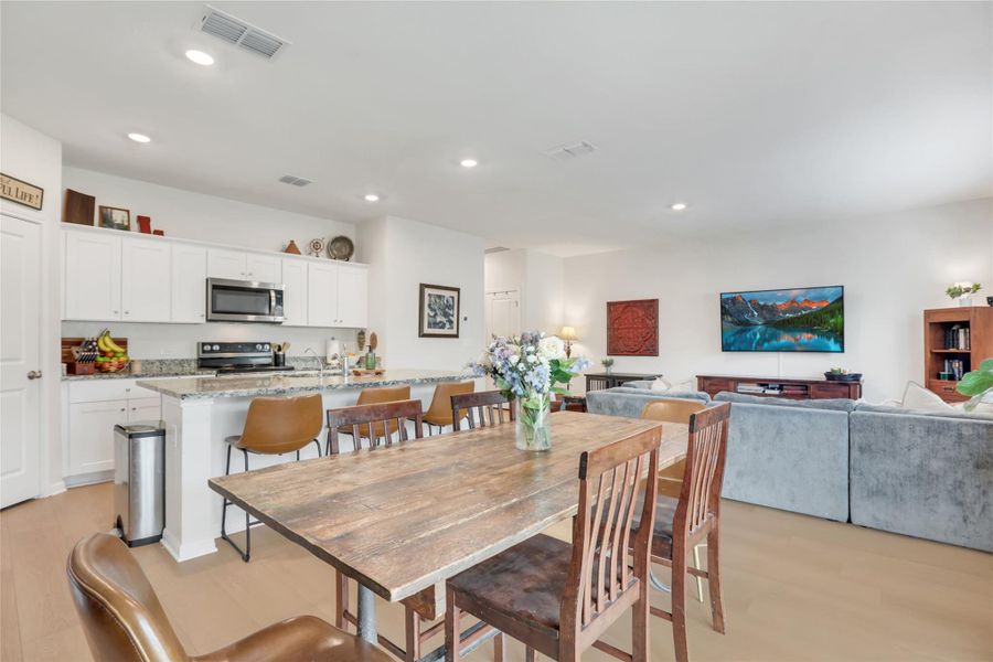 Open concept kitchen, dining, and living space with bright natural light and a seamless flow for entertaining