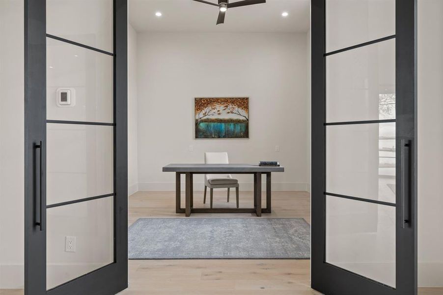 Kitchen with light wood finished floors, ceiling fan, recessed lighting, and baseboards Kitchen with light wood finished floors, ceiling fan, recessed lighting, and baseboards