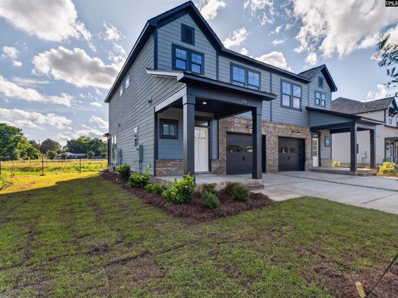 Front exterior of a new home in Dunbar Village, Cayce, SC, highlighting curb appeal (Image 2). Front exterior of a new home in Dunbar Village, Cayce, SC, highlighting curb appeal (Image 2).