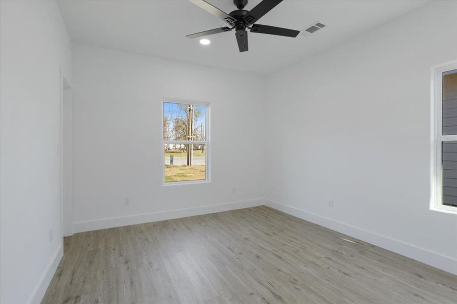 Unfurnished room featuring light hardwood / wood-style floors and ceiling fan