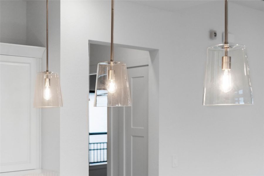 The Clarion pendant light fixtures located over the kitchen countertop gives added light into the kitchen - adding a sleek, reflective accent.