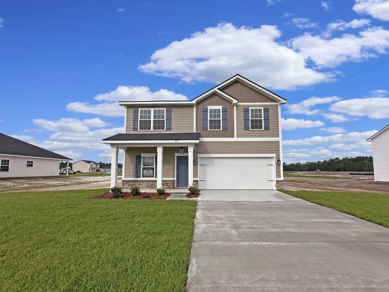 Front exterior of a new home in Doctor's Creek, Ludowici, GA, highlighting curb appeal (Image 1). Front exterior of a new home in Doctor's Creek, Ludowici, GA, highlighting curb appeal (Image 1).