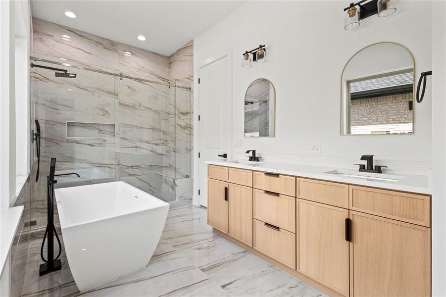 Bathroom featuring tile floors, separate shower and tub, and double sink vanity