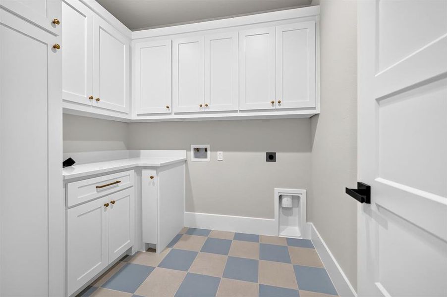 First floor laundry room with extensive cabinetry. Second floor also has stackable washer and dryer designated area. First floor laundry room with extensive cabinetry. Second floor also has stackable washer and dryer designated area.