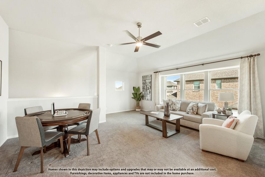 Open living and dining area with ceiling fan, carpet floors, and large windows letting in natural light
