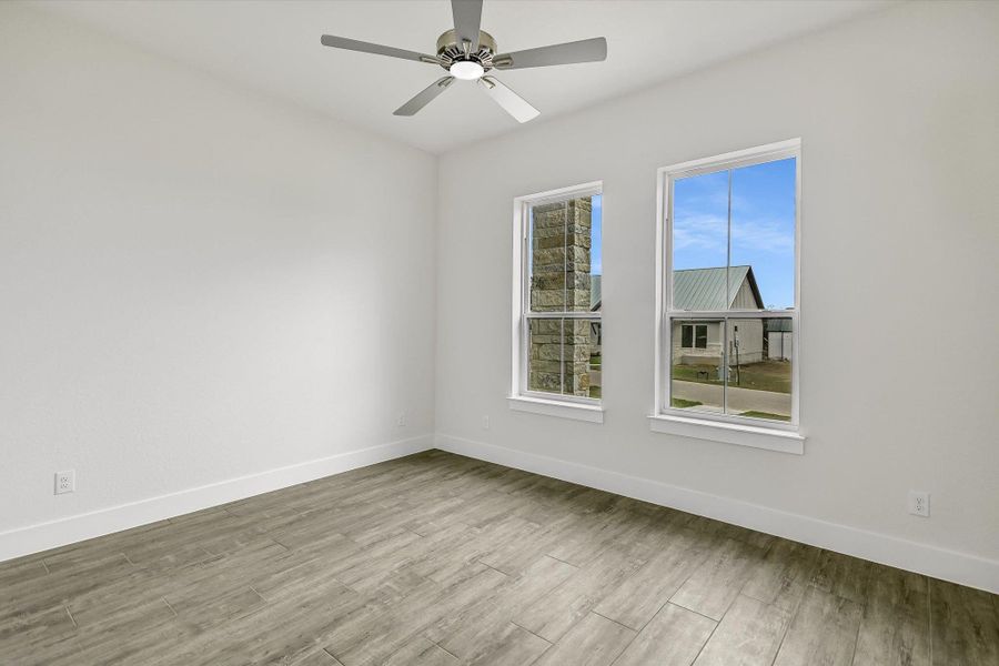 Unfurnished room with light wood-style floors and ceiling fan