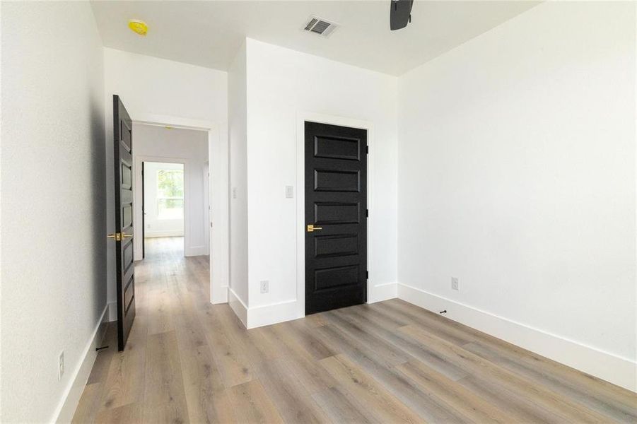 Unfurnished room featuring ceiling fan and light hardwood / wood-style flooring