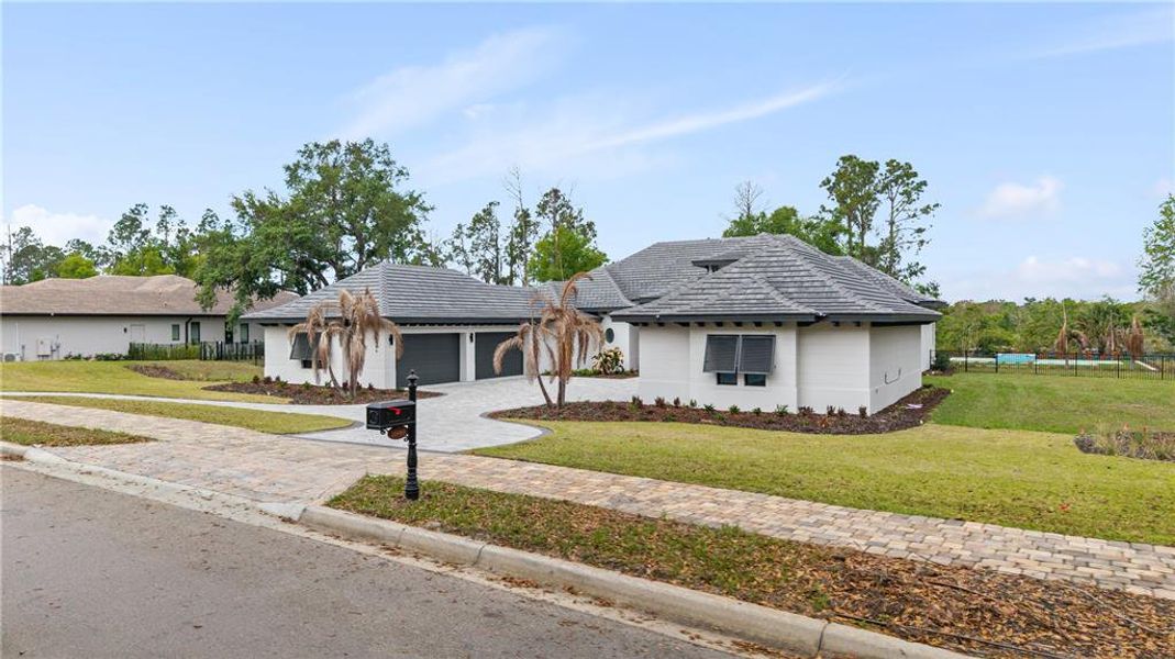 Front exterior of a new home in Bella Collina, Montverde, FL, highlighting curb appeal (Image 21). Front exterior of a new home in Bella Collina, Montverde, FL, highlighting curb appeal (Image 21).