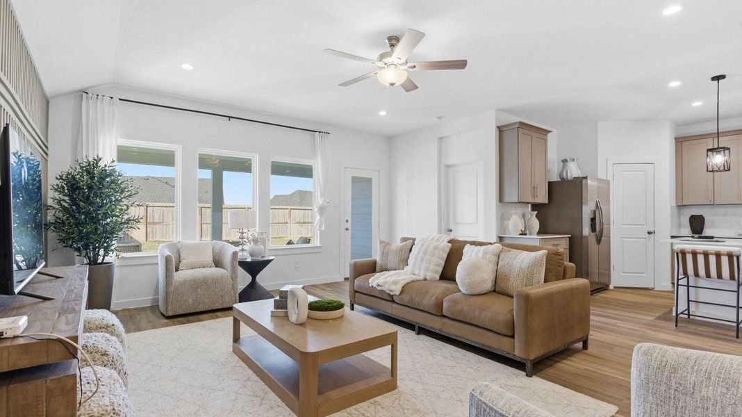 A well-organized living room that includes a kitchen and dining area, creating a warm and welcoming environment for gatherings.