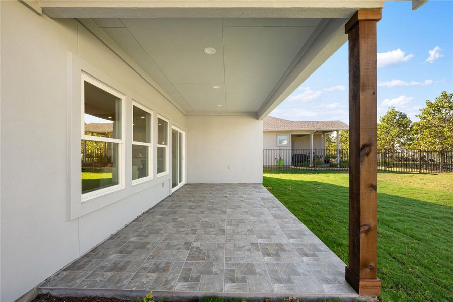 Fenced backyard with a patio