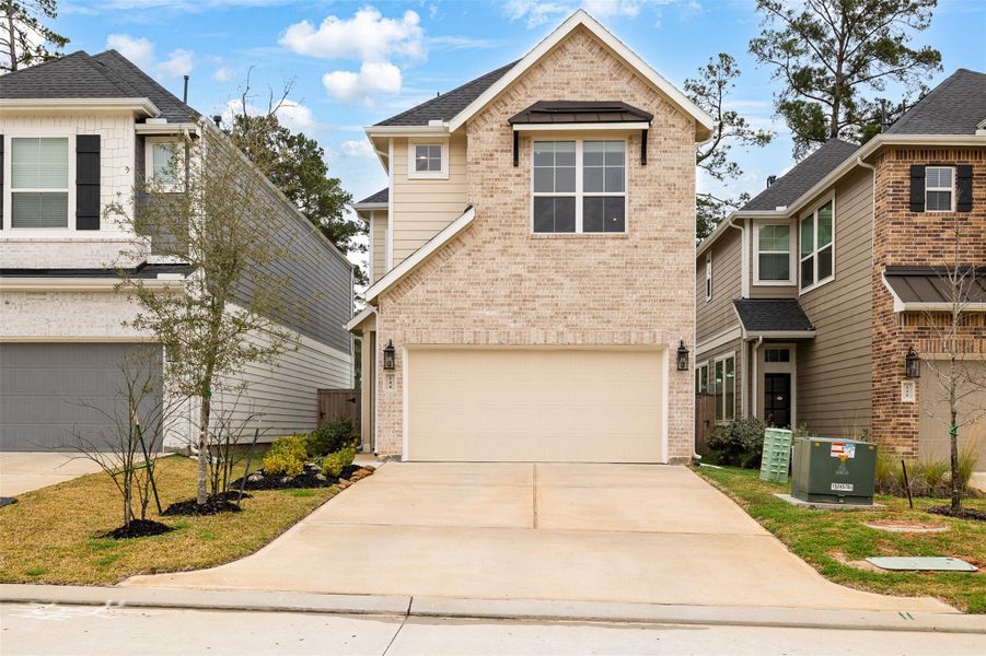 Front exterior of a new home in The Woodlands Hills, Willis, TX, highlighting curb appeal (Image 21). Front exterior of a new home in The Woodlands Hills, Willis, TX, highlighting curb appeal (Image 21).
