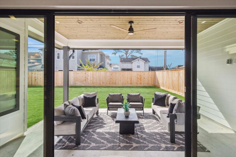 Spacious covered patio with ceiling fan, gas hookup, and prewired for sound system.