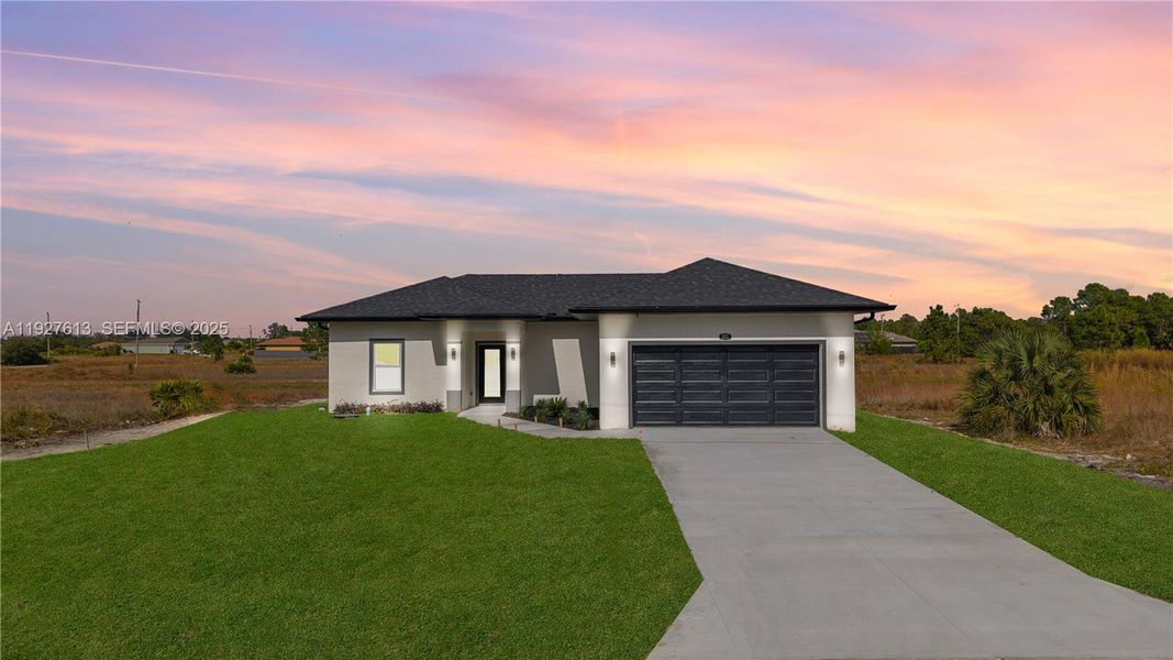 Front exterior of a new home in , Lehigh Acres, FL, highlighting curb appeal (Image 16).