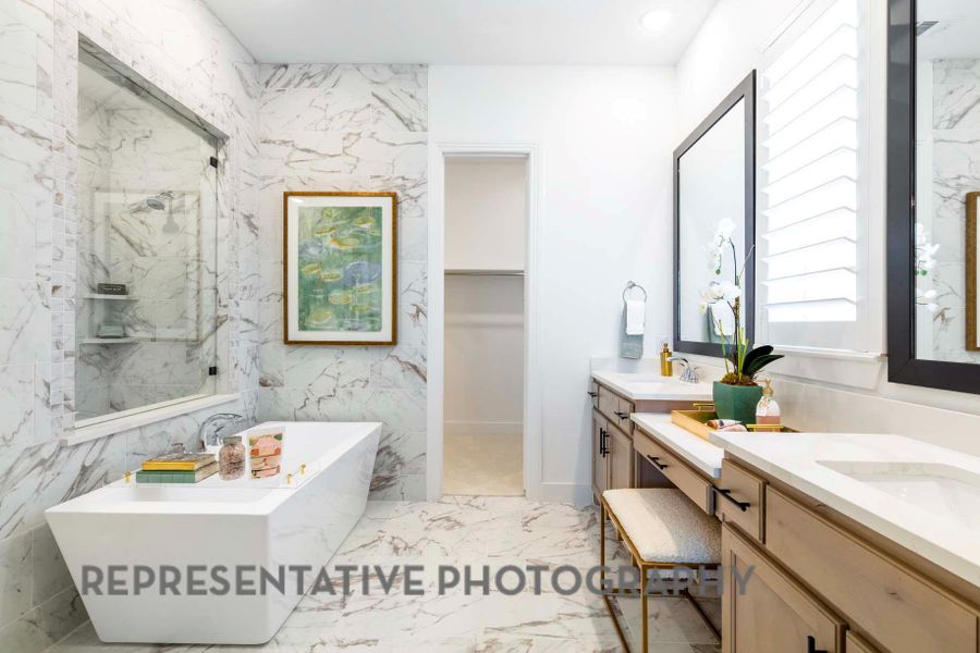 Full bath with marble finish floor, a marble finish shower, vanity, and a freestanding bath Full bath with marble finish floor, a marble finish shower, vanity, and a freestanding bath